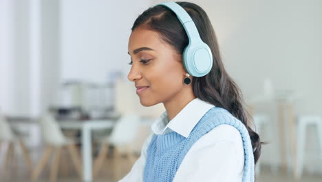 Young-Indian-creative-with-headphones-sitting