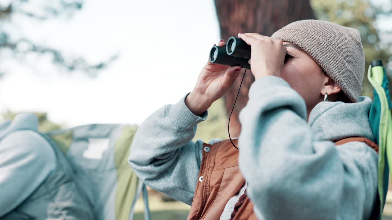 Woman with binoculars exploring nature