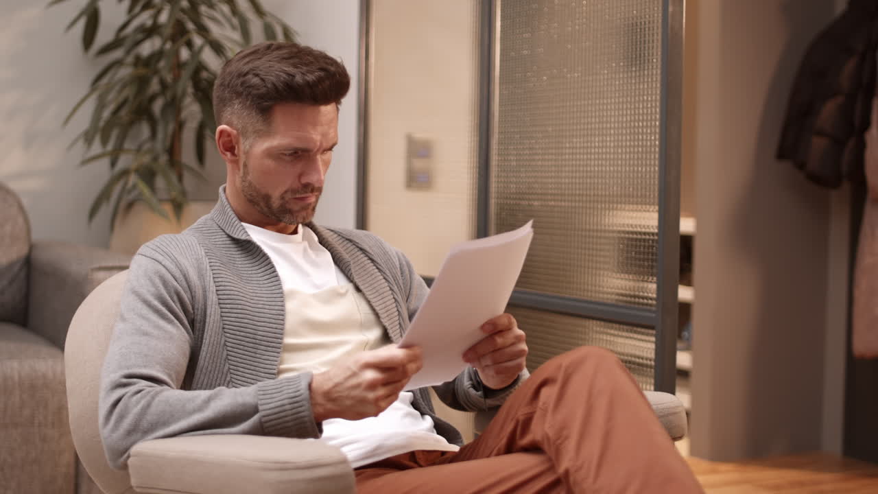 Man Looking Through Documents at Home