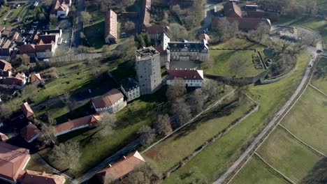 drone aerial view of the fairytale castle adelebsen on a beautiful autmn afternoon in golden sunlight