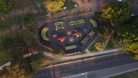 Aerial-top-down-shot-of-kids-playing-games-in-park-during-sunset-time-in-Buenos-Aires,Argentina