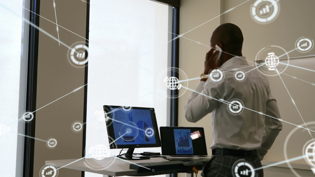 Animation of network of digital icons over african american businessman talking on smartphone