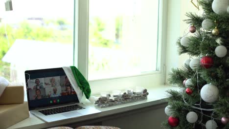 Frau-Telefoniert-Auf-Einem-Laptop-Und-überreicht-Ein-Weihnachtsgeschenk,-Konzept-„Weihnachten-Zu-Hause“.