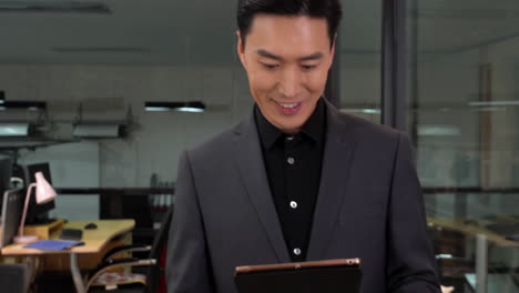 mature business man walking in office, using touchpad computer for work. busy professional businessman going in hallway holding digital tablet thinking of work plan using tab computer