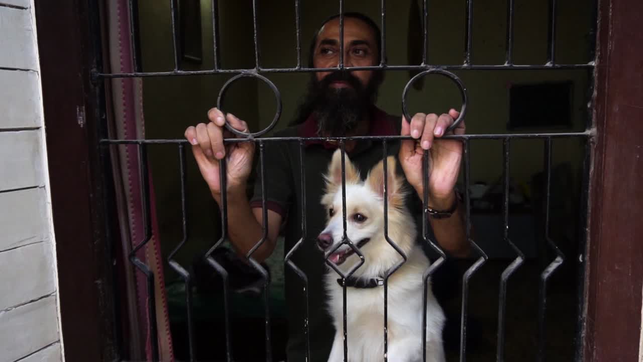 Indian spitz dog  and old man wants to come out in lockdown
