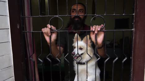 indian spitz dog  and old man wants to come out in lockdown