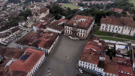city centre of the brazilian colonial mining town of ouro preto in minas gerais. aerial slow pan around the central square tirdadentes