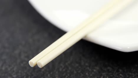 pair of chopsticks and plate