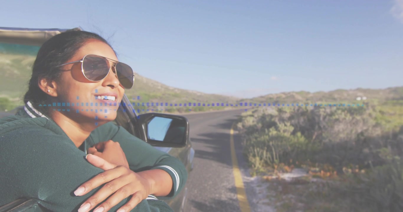 Woman leaning from car window on drive relaxing fixing shades blue-dots tracking yellow line travel