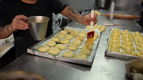 applying glaze to pastries before baking