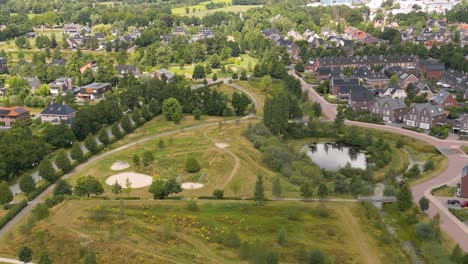 Aerial-drone-shot-above-the-city-of-Leek-with-a-nature-park,-province-of-Groningen,-Netherlands