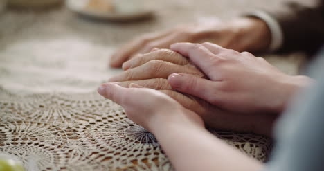 woman comforting wrinkled old hand 3