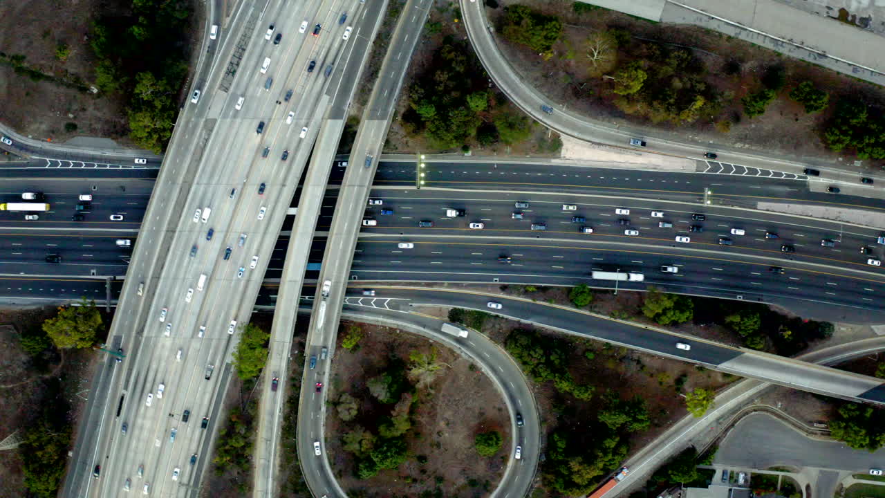 Aerial view of a busy highway interchange with multiple lanes of traffic