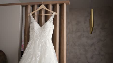 A-beautiful-white-wedding-dress-hangs-on-a-hanger-in-the-wardrobe-in-the-bedroom