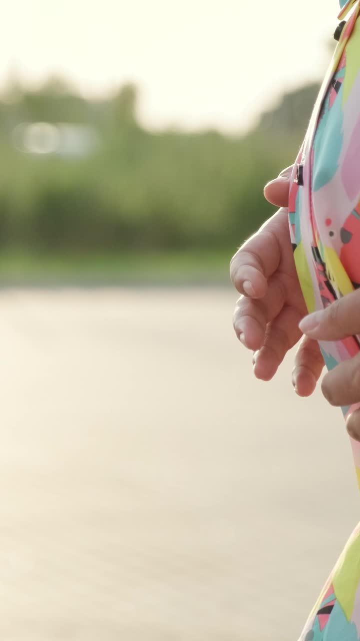 Images of a pregnant woman in a colorful floral dress
