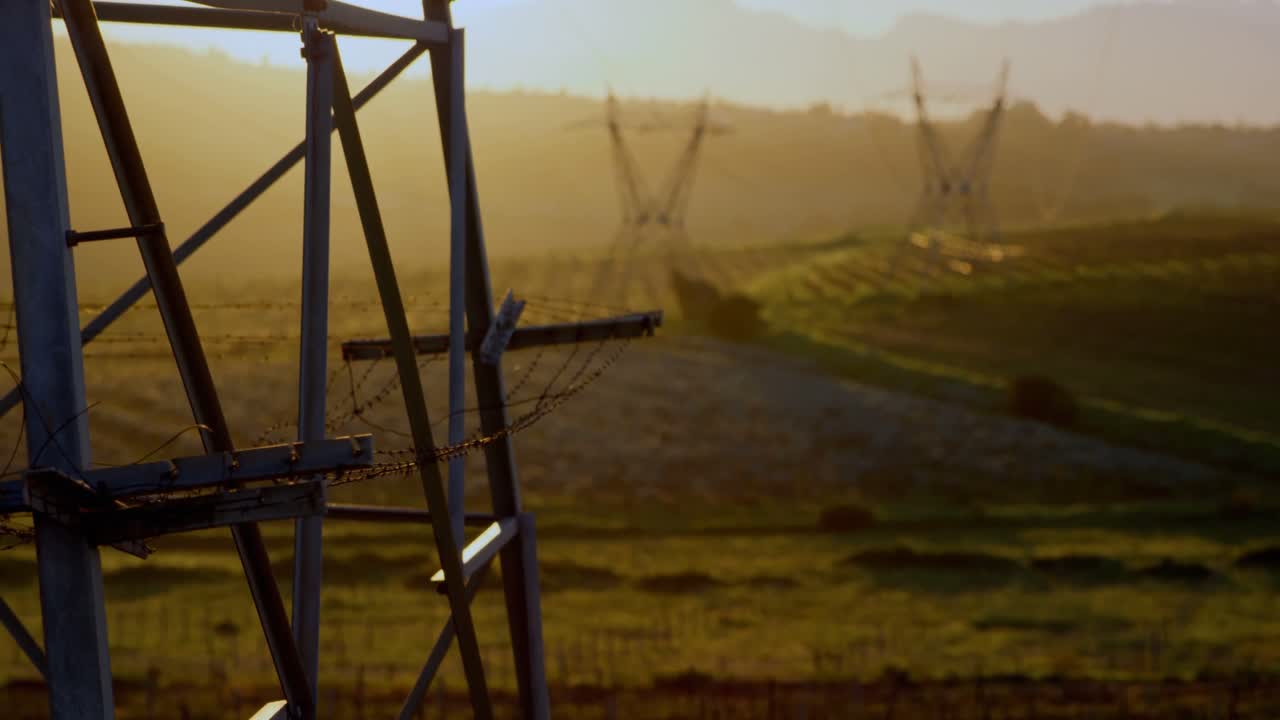 Electricity pylons during sunset 4k