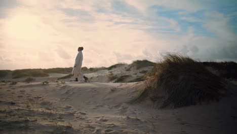 lonely woman walking sand dunes. dreamy tourist enjoying weekend trip outdoors.