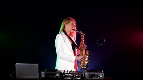 woman playing saxophone at dj set