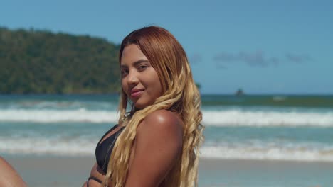 amidst a tropical paradise, a young woman in a bikini savors the allure of a caribbean beach with white sand with ocean waves in the background