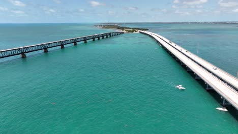 aerial pullout over seven mile bridges in the florida keys with boats, fishing boats around bridge