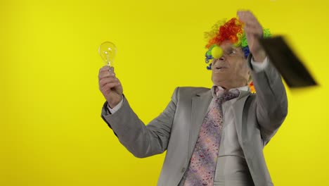 senior clown businessman entrepreneur show light bulb. came up with great idea