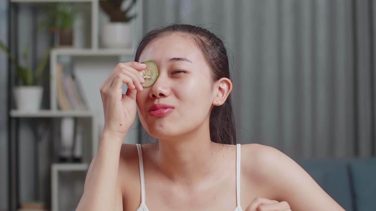 Woman with cucumber slices on her eyes