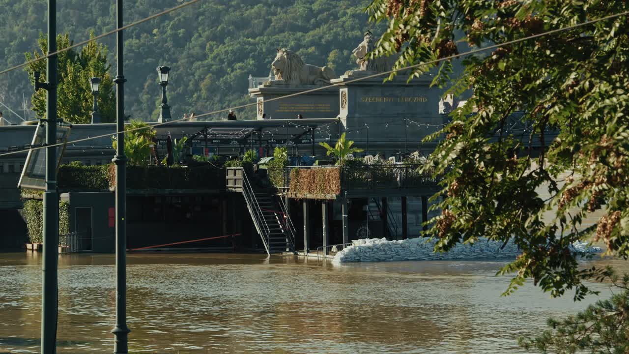 Flooded Restaurant near a Bridge with Lion Statues
