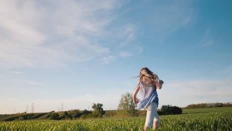 A-Child-Has-Fun-In-A-Green-Meadow-In-Summer