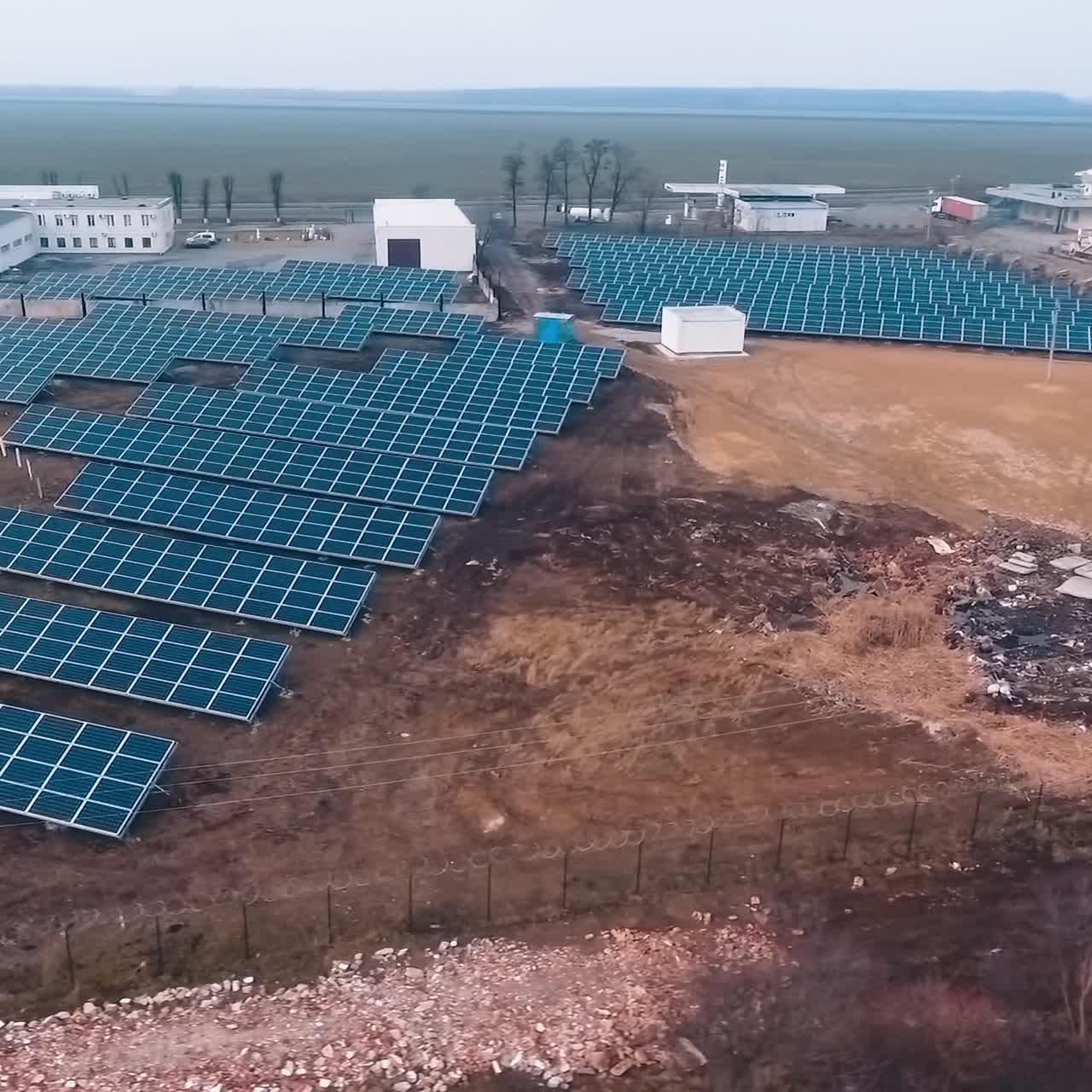 Modern solar farm among nature. Photovoltaic solar panels on the field collect ecological energy from the sun. Sustainable energy.