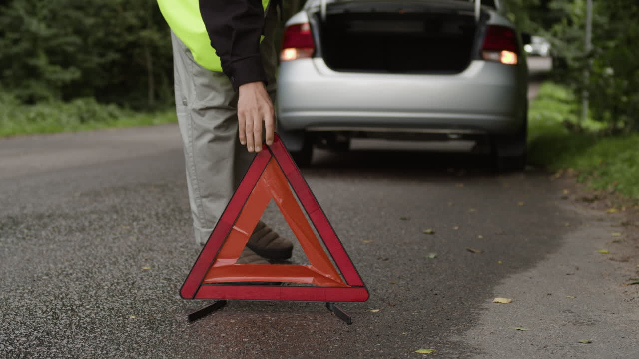 Car emergency on the road with a warning triangle