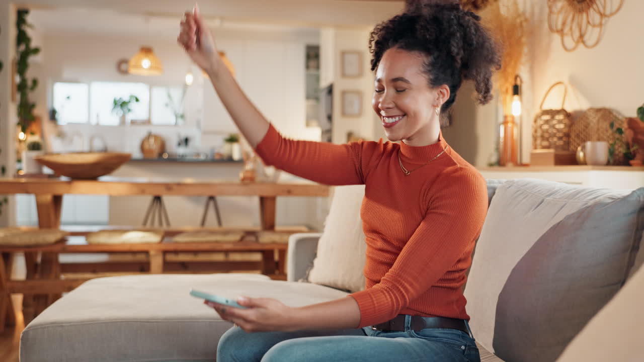 Woman Relaxing on Sofa and Using Phone