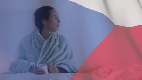 bandera checa ondeando contra mujer toser mientras bebe café en la cama
