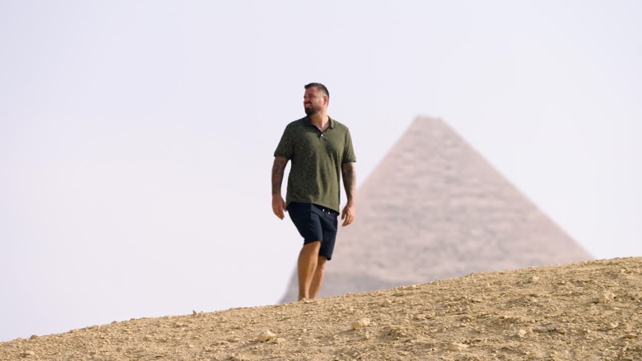 A Tourist Taking in the View of the Giza Plateau, With the Pyramid Visible in the Distance Near Cairo, Egypt - Tracking Shot