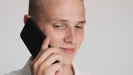 blond blue eyed man talking on the phone