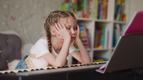 bored schoolgirl with braids looks at musical sheets