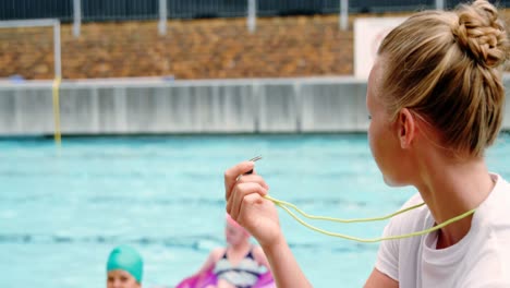 Portrait-of-swim-coach-holding-whistle