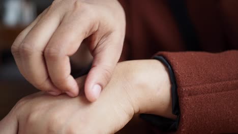 person checking their wrist for an itch