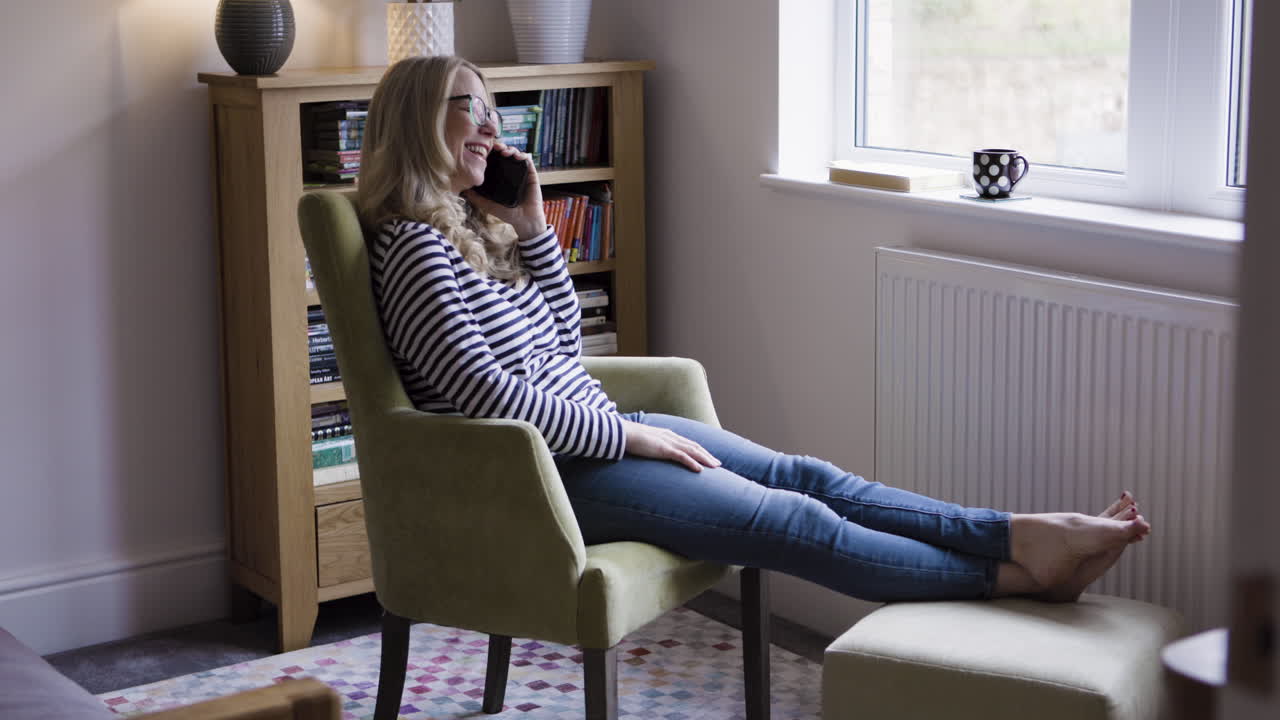 A woman relaxing at home while on the phone