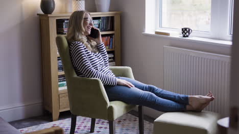 a woman relaxing at home while on the phone