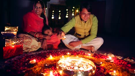 young parents with daughter celebrate decorate for diwali festival