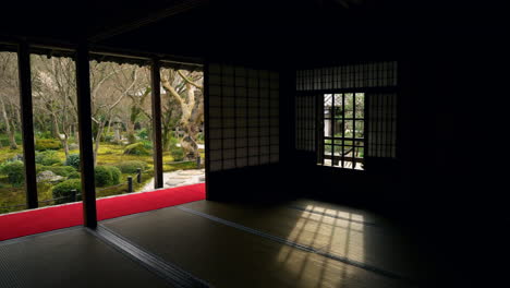 garden view from wooden interior of enko-ji temple in kyoto, japan