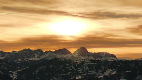 golden sunset over the alps with paragliding