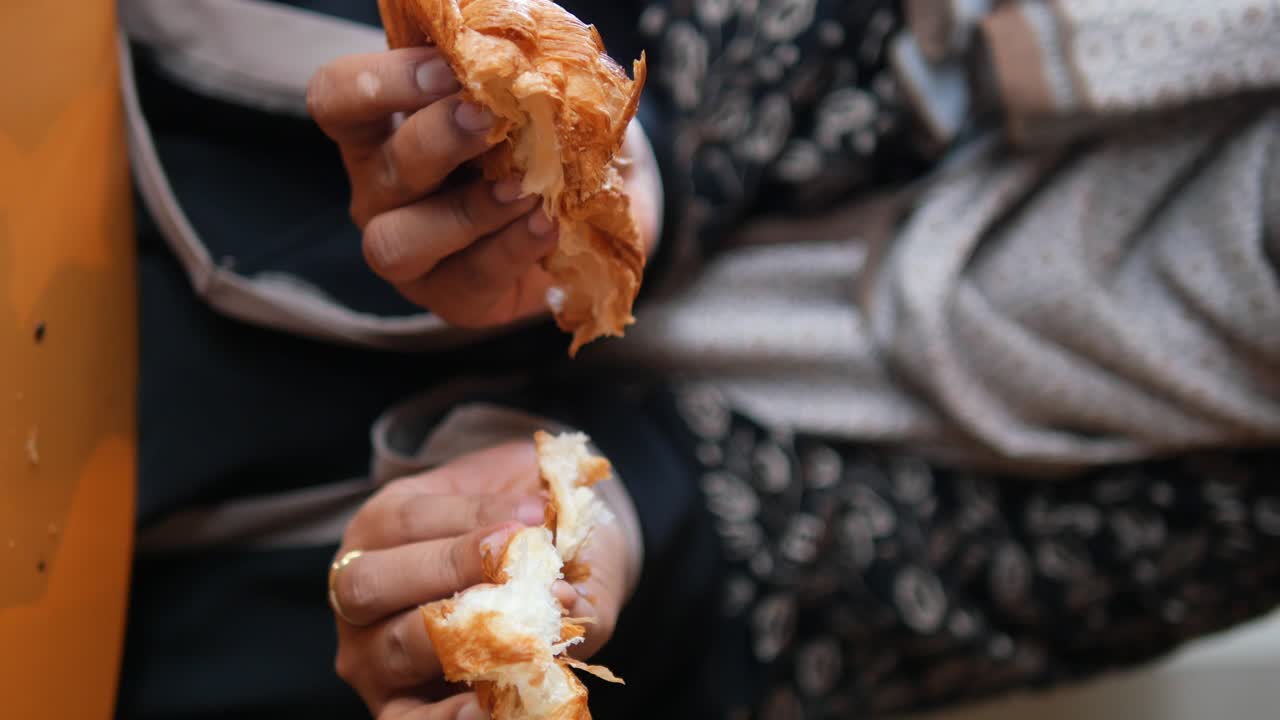 Croissant being held by a person