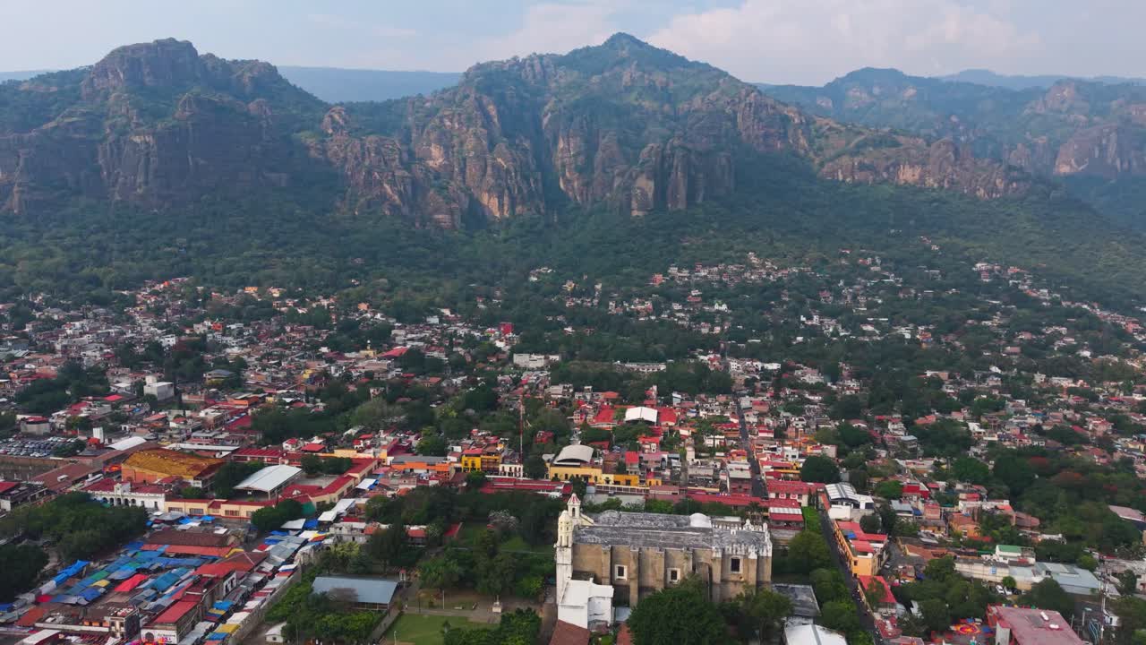 Drone view capturing picturesque town of Tepoztlán amid mountain scenery