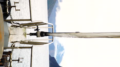 bow view of luxury sailboat while sailing in fiordland national park, vertical view