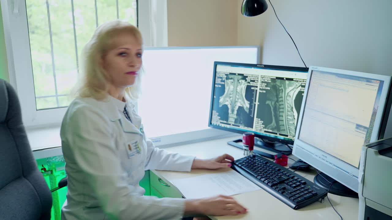 Professional Doctor Looking At MRI. Medical team operating computers in CT scan lab