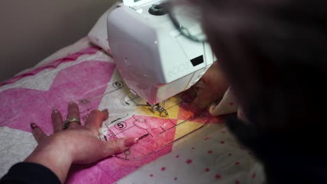 sewing a patterning on a handmade quilt using a sewing machine and a plastic template