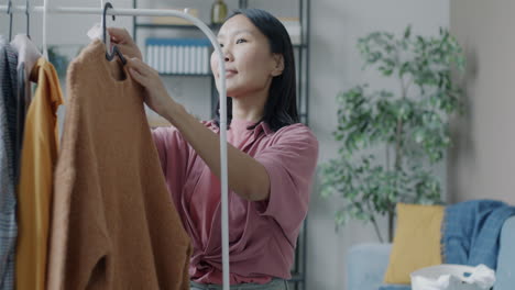 Woman choosing clothes in her home wardrobe