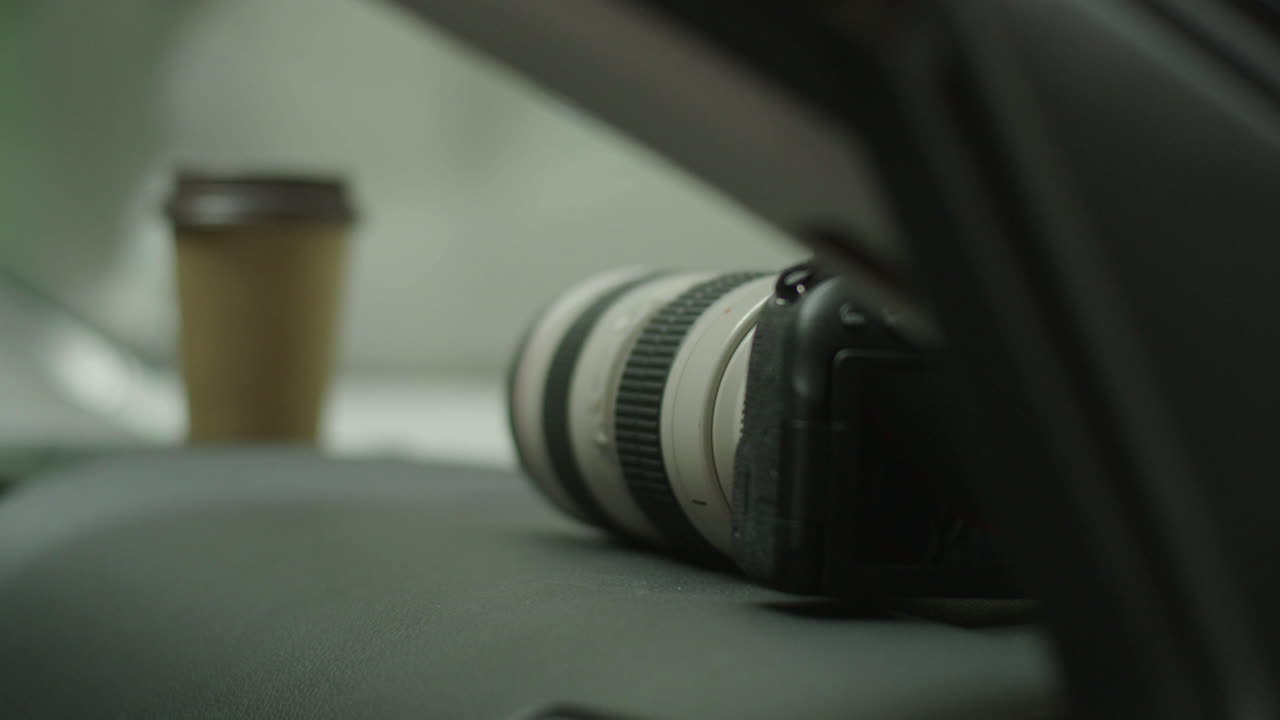 Camera and Coffee Cup in a Car