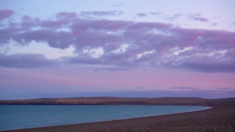 time-lapse of clouds drifting over remote argentine atlantic coast in patagonia with sunset pastel colors